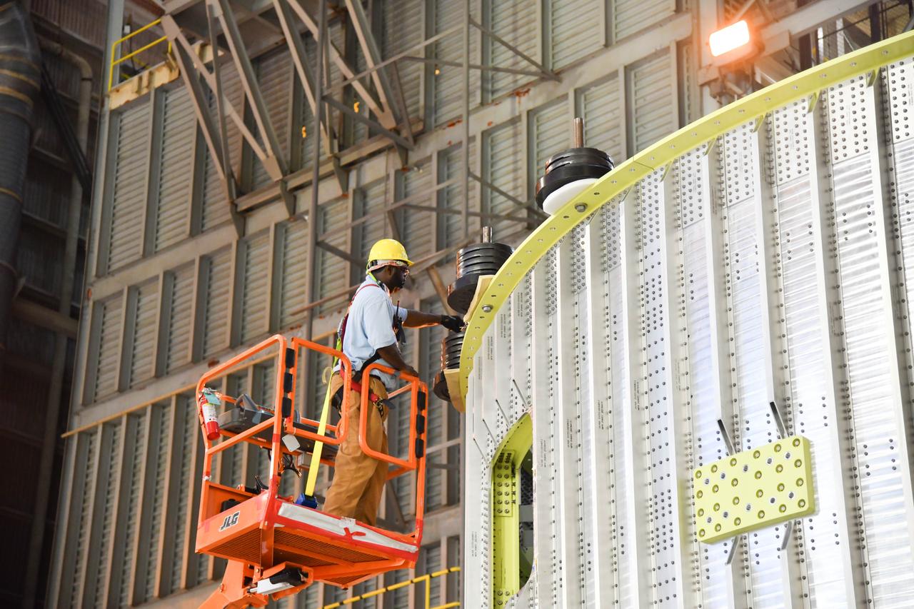 The Space Launch System (SLS) rocket’s liquid oxygen tank structural test article was manufactured and stacked in June 2019 at NASA’s Michoud Assembly Facility in New Orleans. To construct the test article, Boeing technicians at Michoud moved the liquid oxygen tank to the Vertical Assemby Building stacking and integration area. Here, they added simulators to mimic the two structures that connect to the tank, the intertank and the forward skirt.  This structural hardware for the SLS core stage for America’s new deep space rocket is structurally identical to the flight version of the tank. It will be shipped on the Pegasus barge to NASA’s Marshall Space Flight Center in Hunstville, Alabama, where it will undergo a series of tests that simulate the stresses and loads of liftoff and flight. These tests will help ensure designs are adequate for successful SLS missions to the Moon and beyond. The flight liquid oxygen tank along with the liquid hydrogen tank supplies more than 500,000 gallons of propellant to the core stages four RS-25 engines, which produce 2 million pounds of thrust to help send the SLS rocket to space.